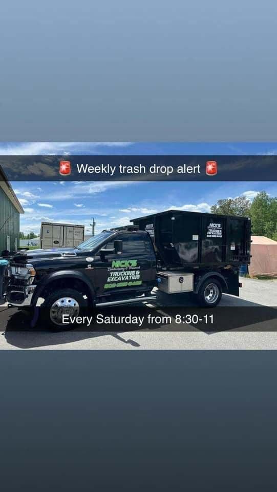A black truck is parked on the side of the road.