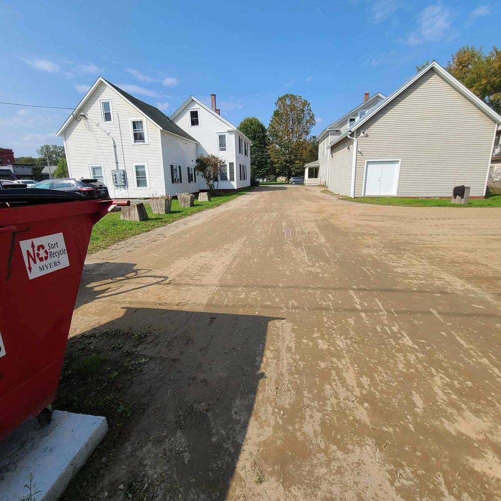 A red dumpster with the word nc on it