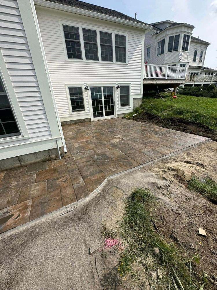 A large white house with a patio in front of it.