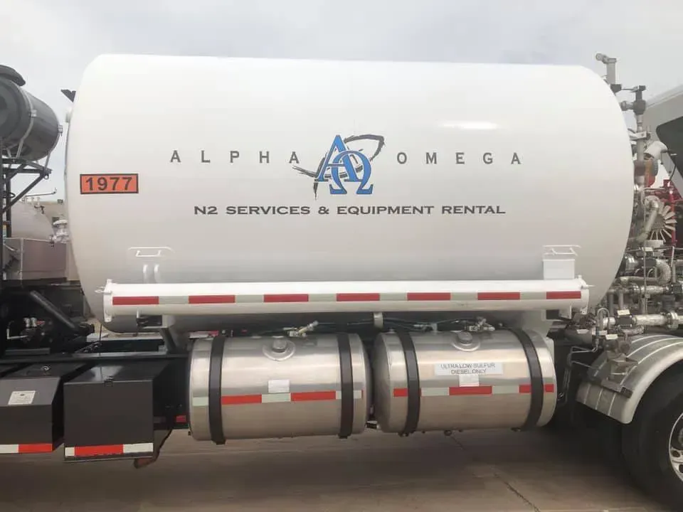 An alpha omega truck is parked in a parking lot