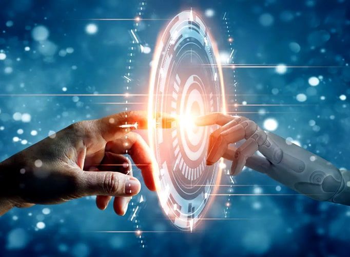 A man and a robot are touching each other 's hands.