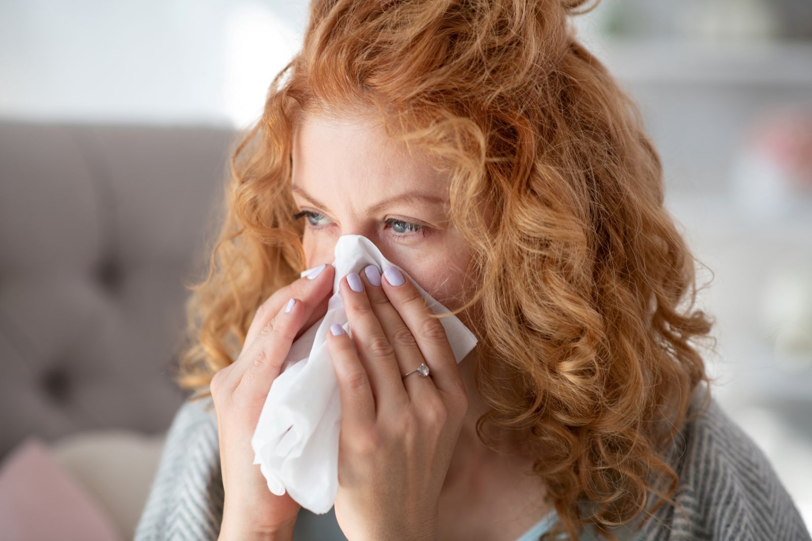 young-woman-blowing-her-nose-on-a-tissue-due-to-sinus-infection