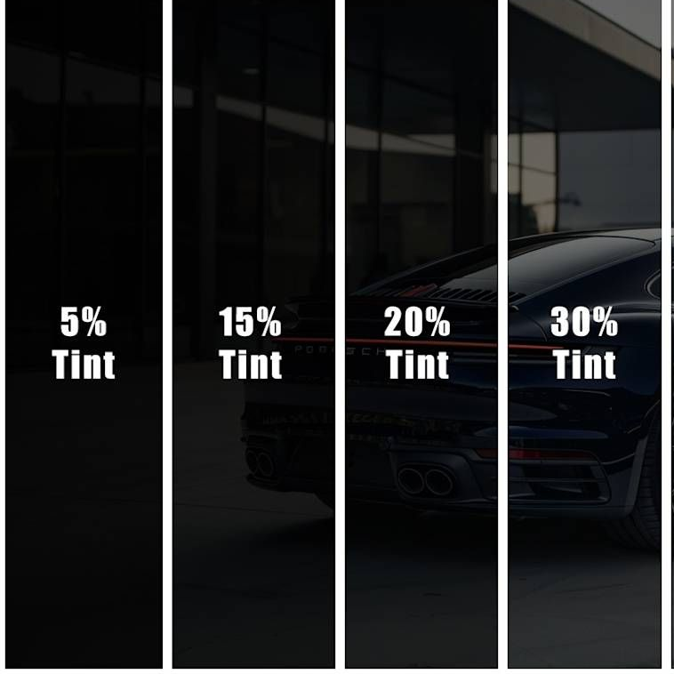 A silver car is parked in a garage next to other cars.