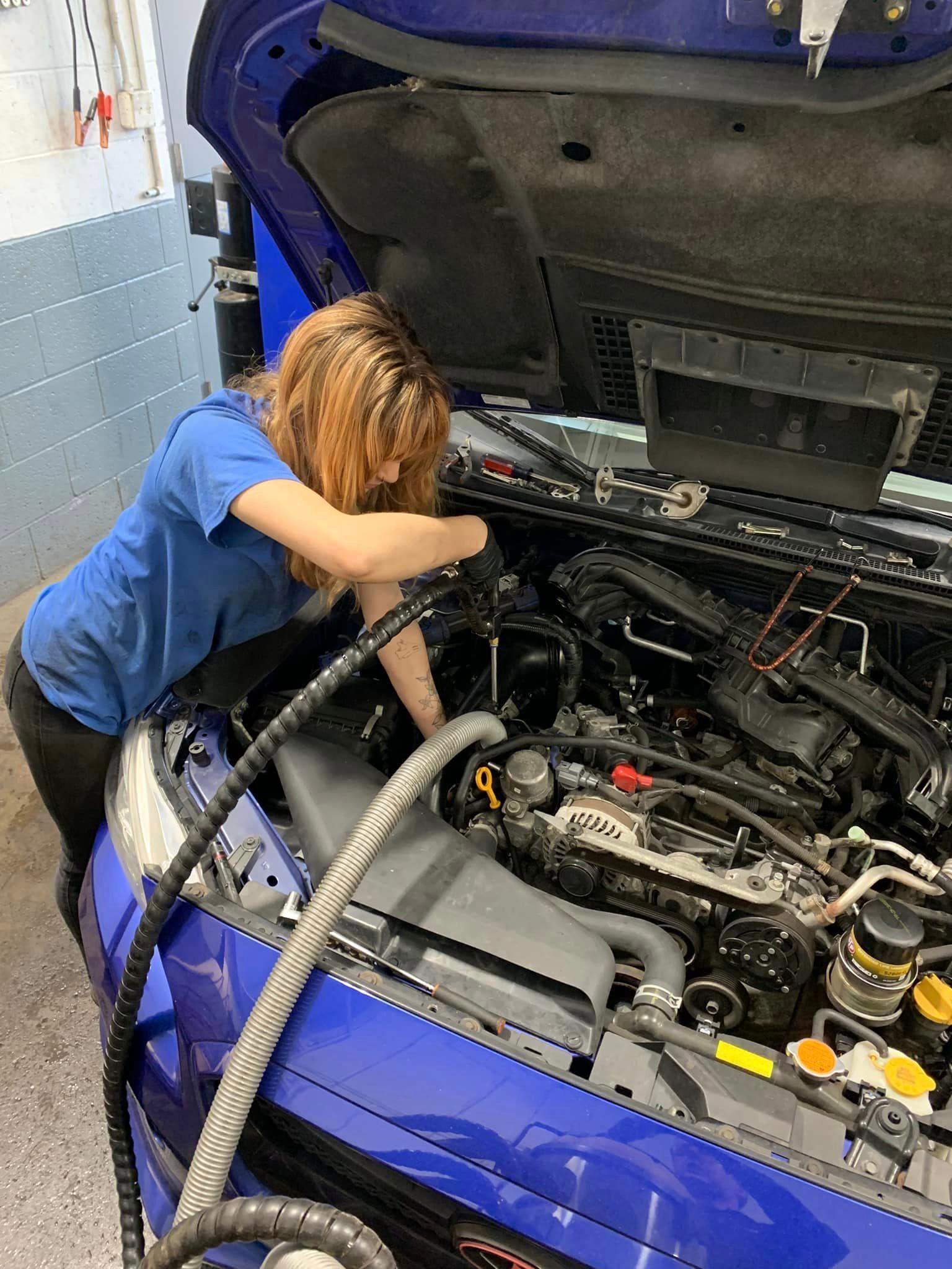 Female Mechanic Working on a Vehicle | Autoworx Robinson