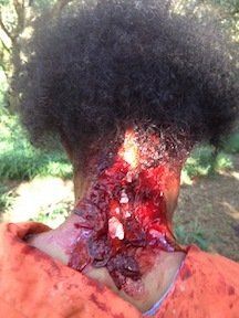 Gory makeup on back of womans head