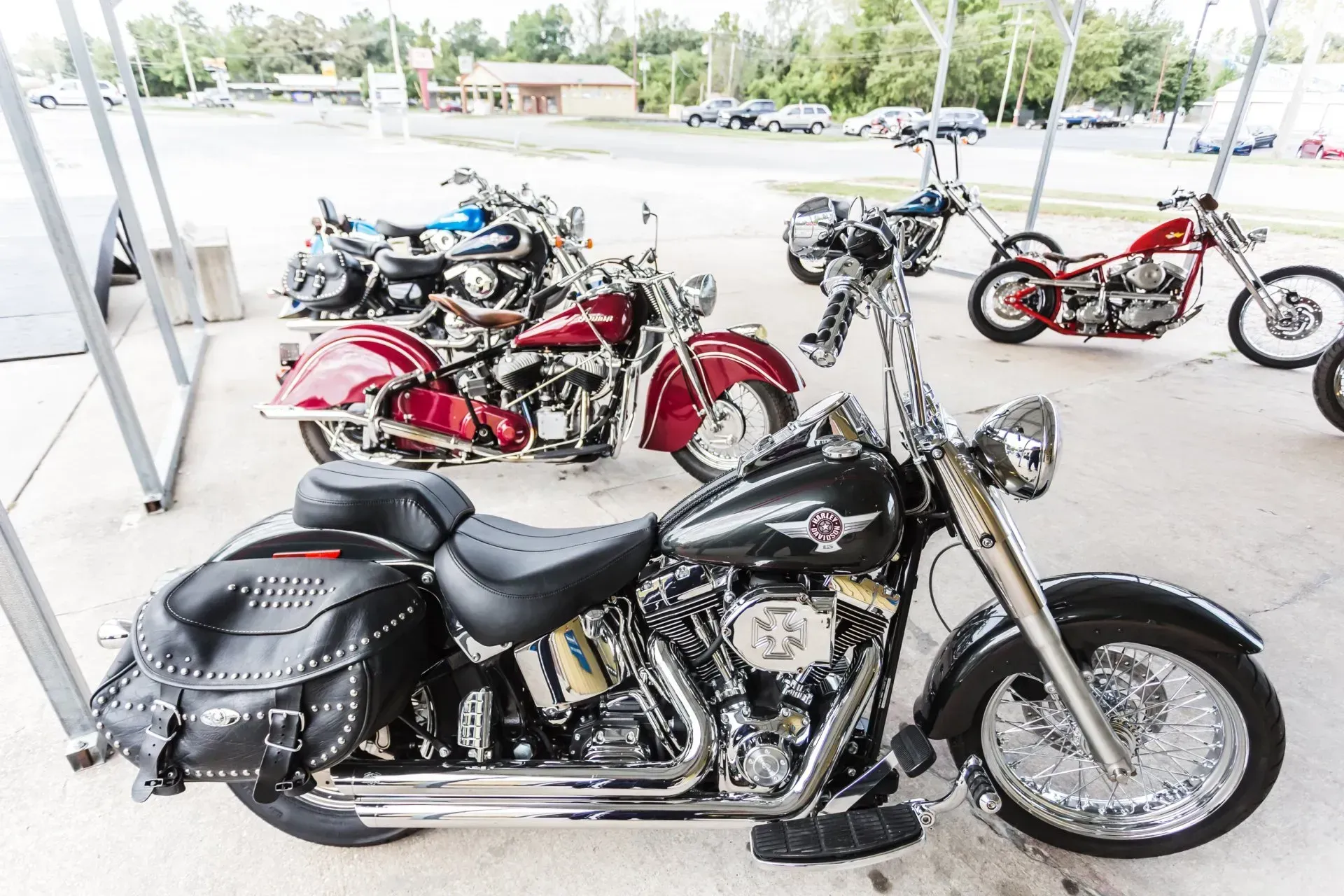 Several motorcycles parked under a canopy. 