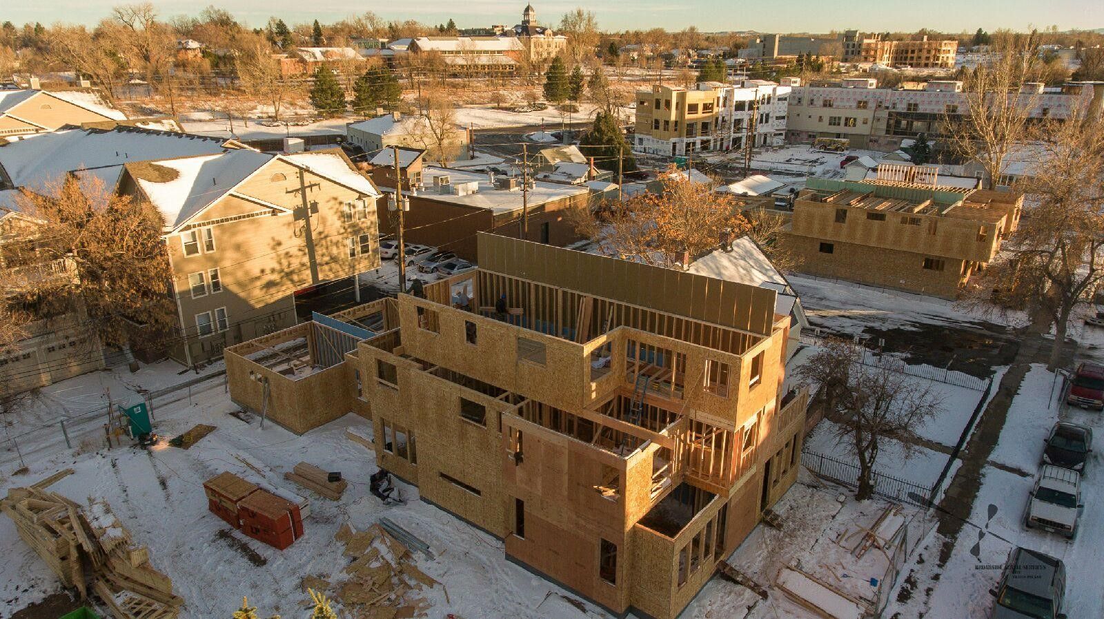 An aerial view of a house under construction in the snow