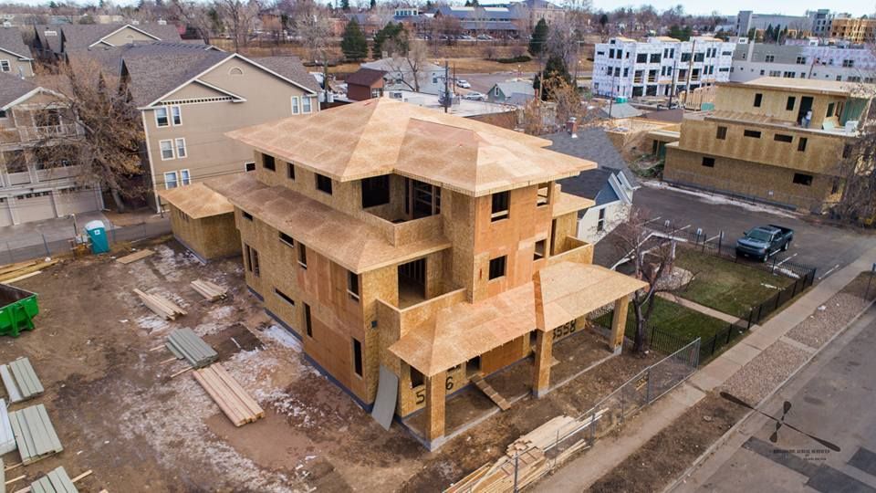 An aerial view of a house under construction in a city.