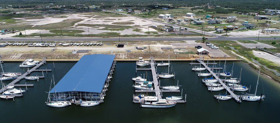 An aerial view of a marina with boats docked in it.