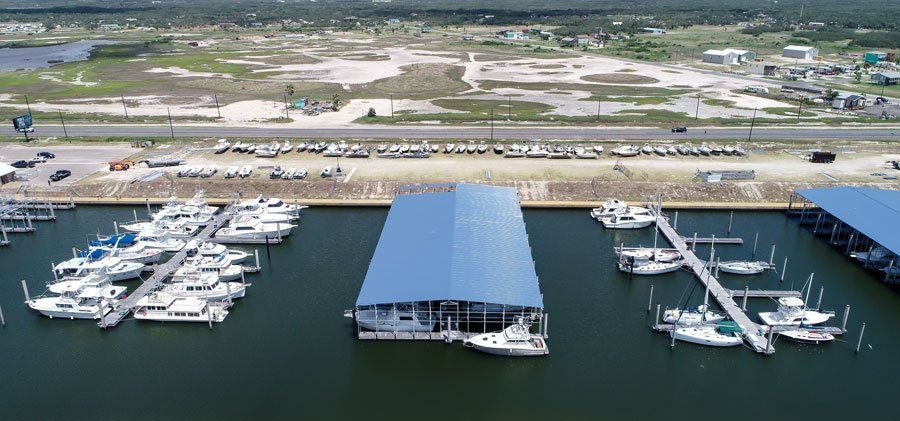 An aerial view of a marina with boats docked in it.