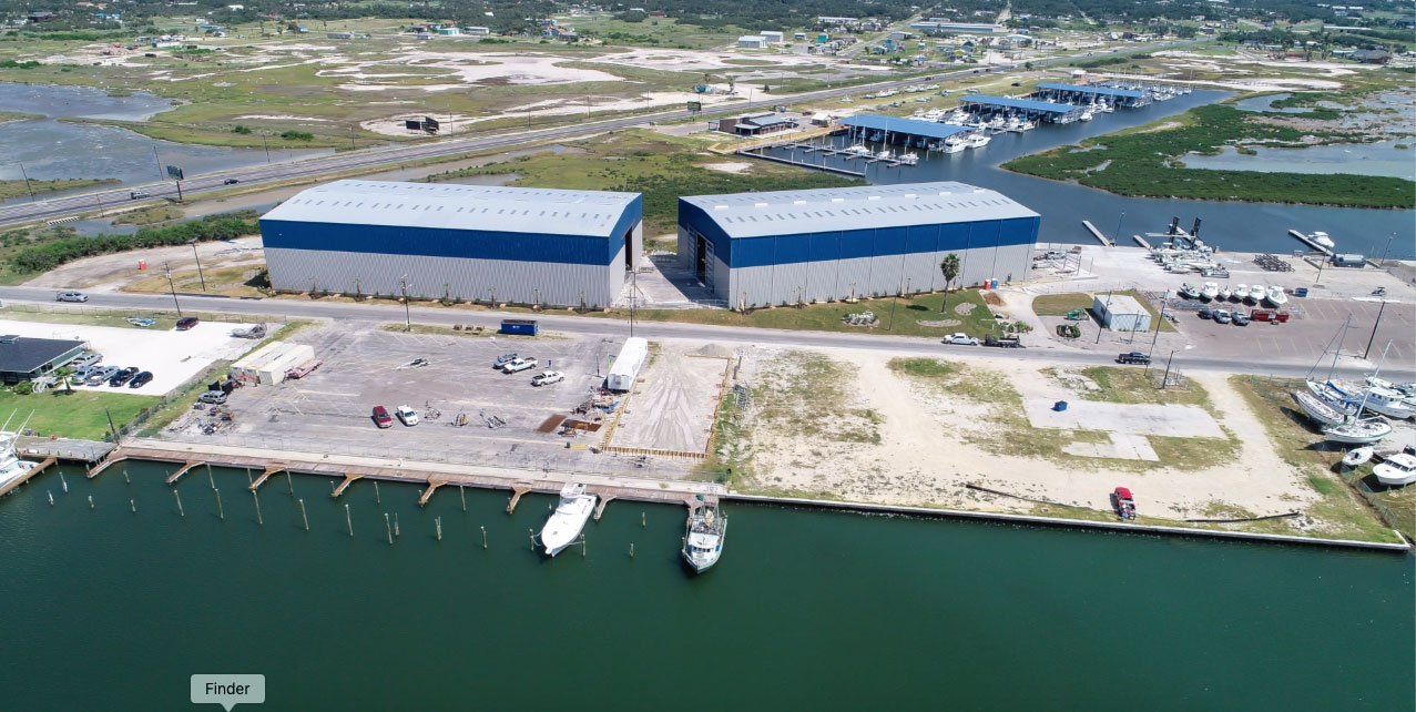 An aerial view of a marina with boats docked in the water.