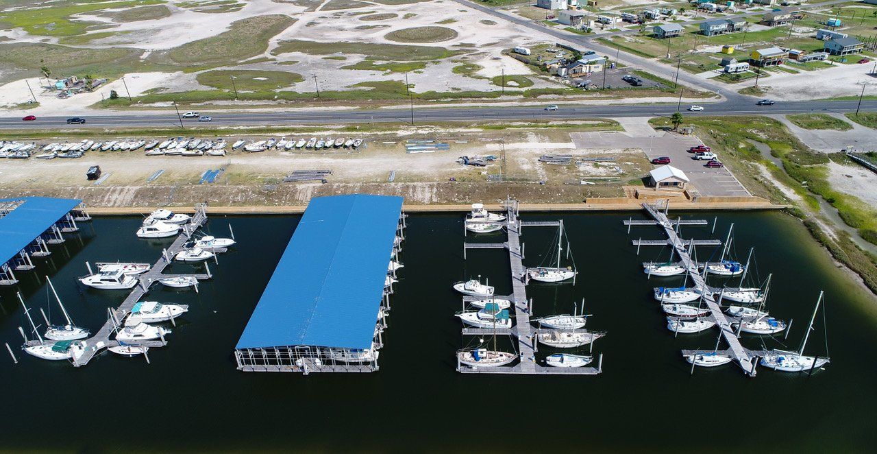 An aerial view of a marina with boats docked in it.