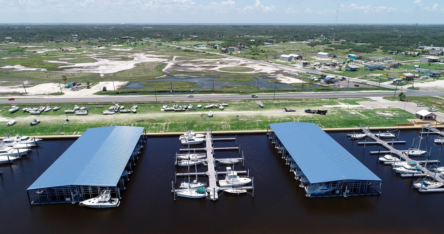 An aerial view of a marina with boats docked in it.