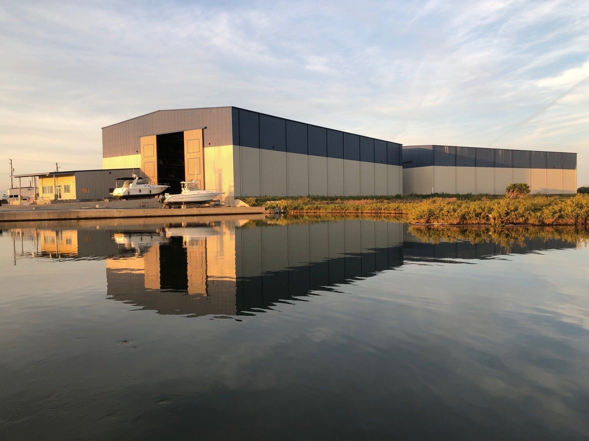 A large building is reflected in a body of water.