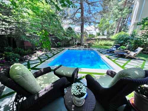 home pool surrounded by greenery