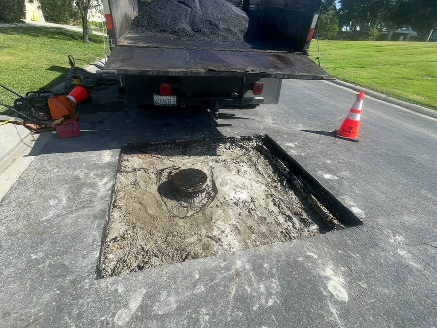 An aerial view of a man laying asphalt on a road.