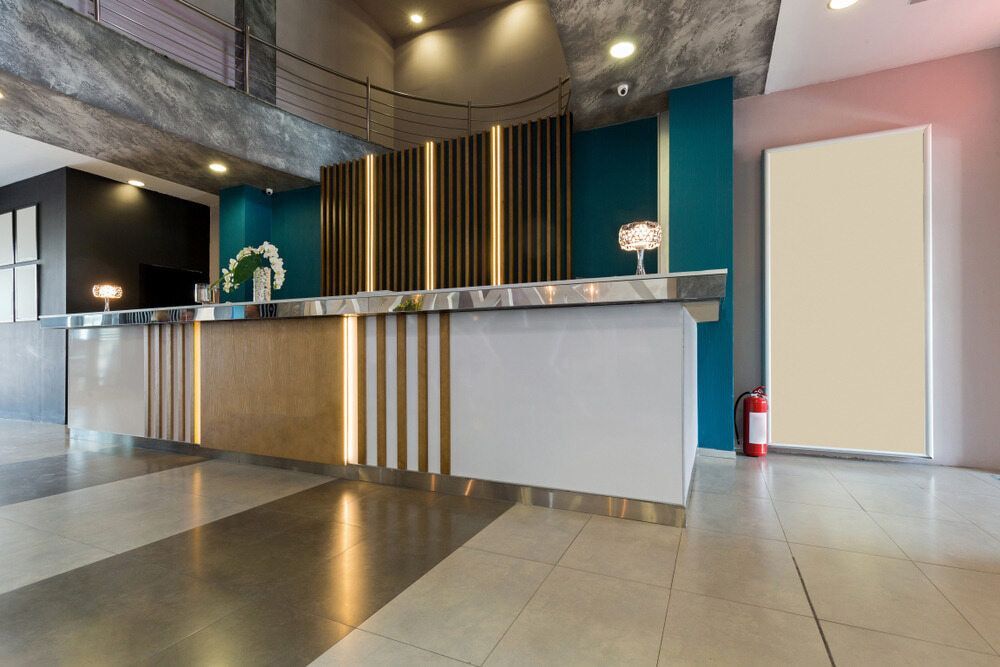 A Hotel Lobby With a Reception Desk and a Fire Extinguisher — Gray Projects in Woodford, QLD