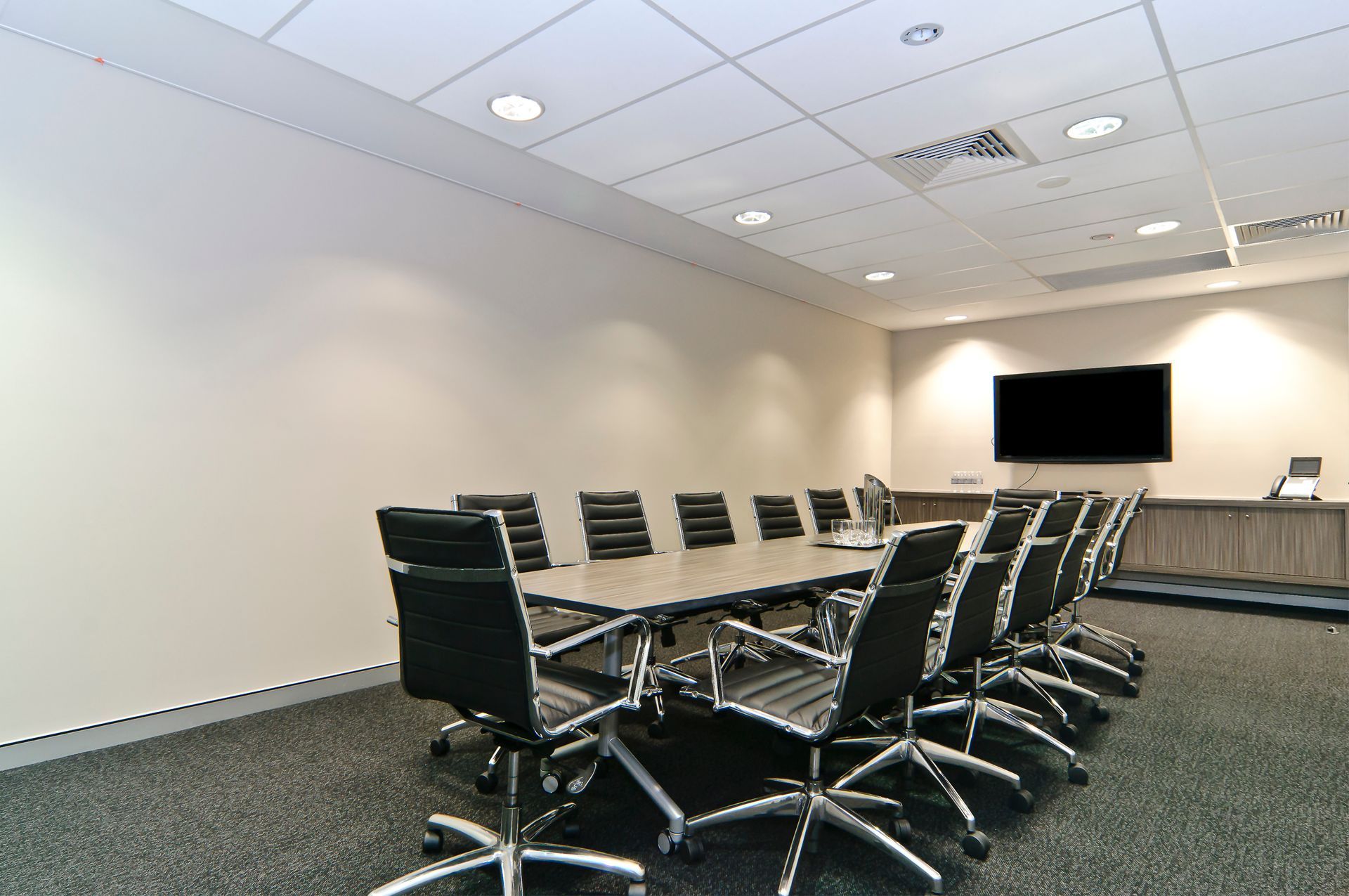 A Modern Boardroom With a Long Table, Black Office Chairs — Gray Projects in Woodford, QLD