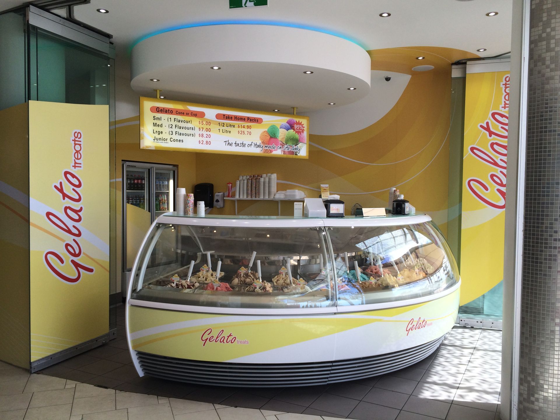 A Gelato Messina Shop With a Yellow, Curved Service Counter — Gray Projects in Woodford, QLD