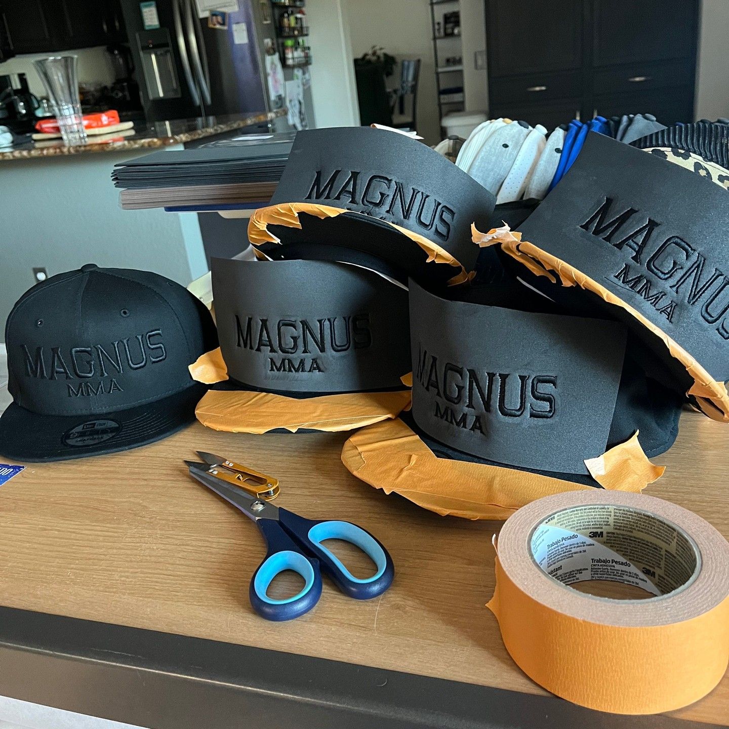 Several magnus mma hats are sitting on a table