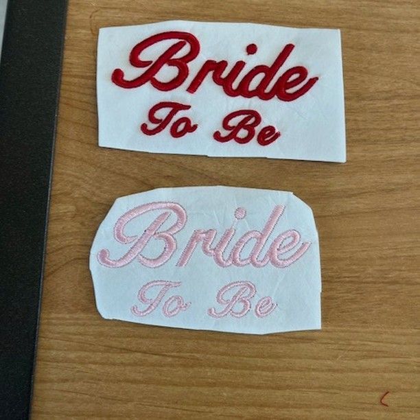 Two pieces of paper with bride to be written on them