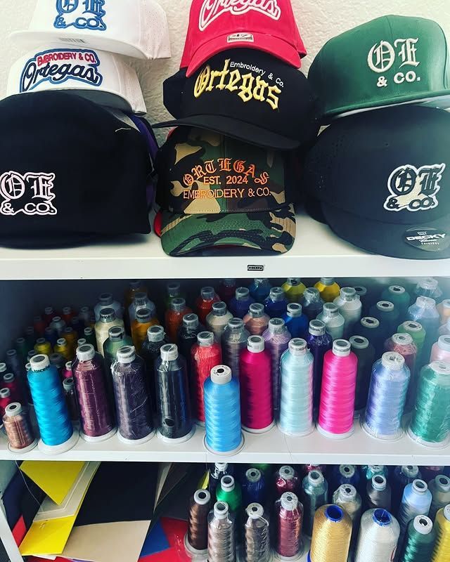 A shelf full of hats and spools of thread