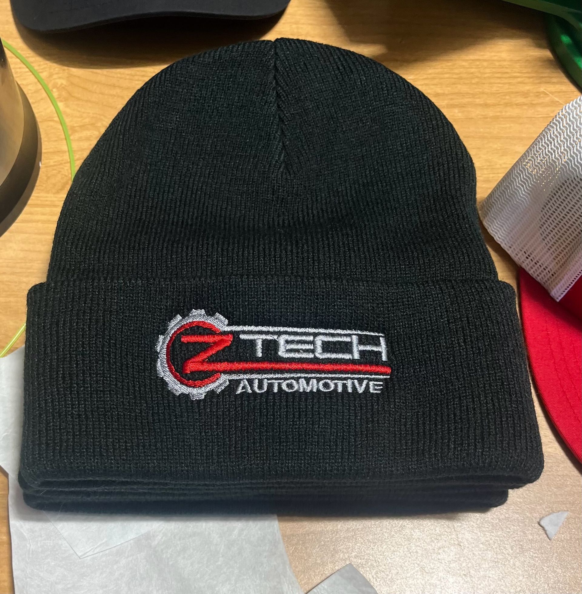 A jacket and a t-shirt are hanging on a rack