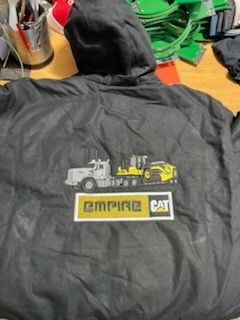 Black jacket with hood, Empire CAT logo and machinery graphic on back.