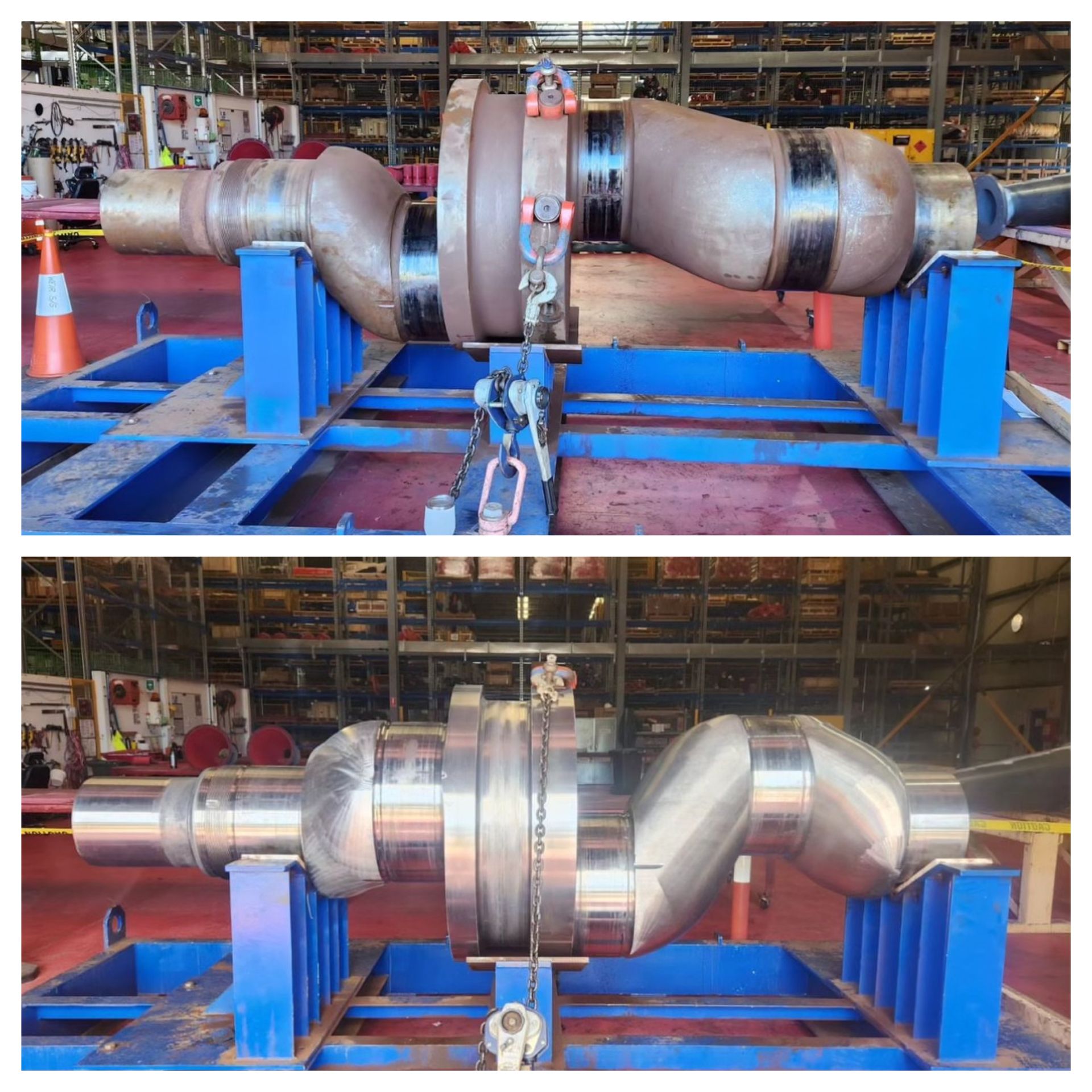 A large metal object is sitting on a blue stand in a warehouse.