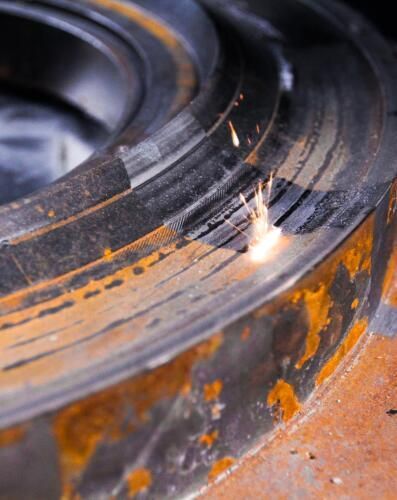 A close up of a piece of metal being cut with a laser.