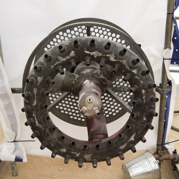 A large metal wheel with holes in it is sitting on a table