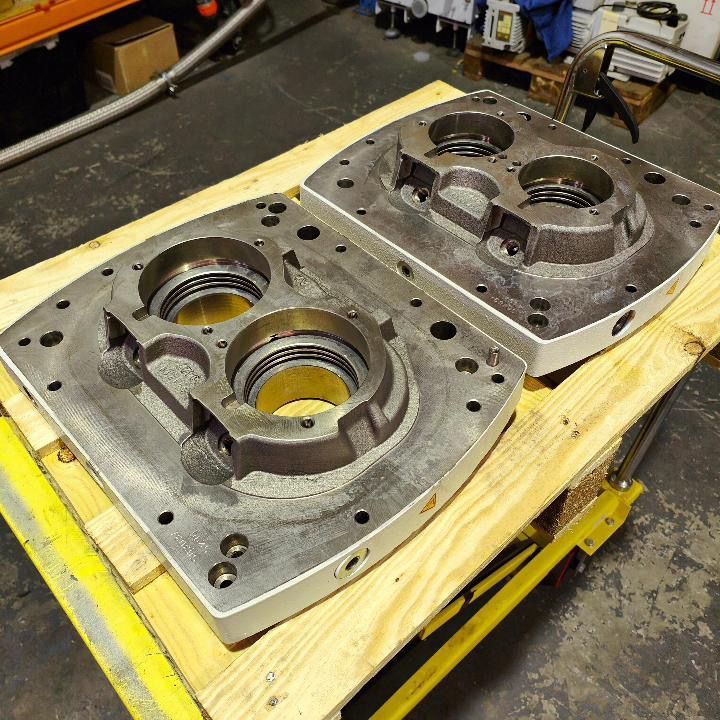 Two pieces of metal are sitting on a wooden table