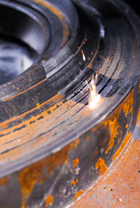 A close up of a piece of metal being cut with a laser.