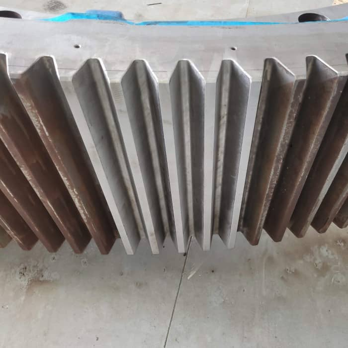 A close up of a metal gear on the ground