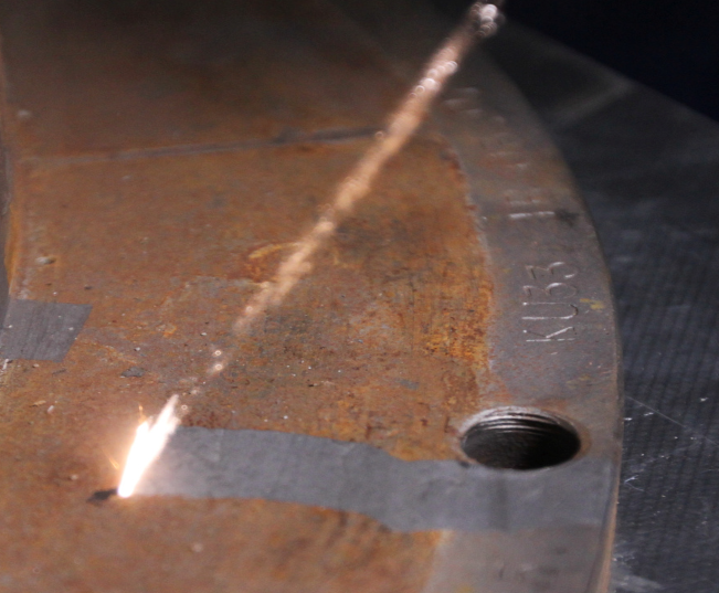 A close up of a piece of metal with a hole in it.