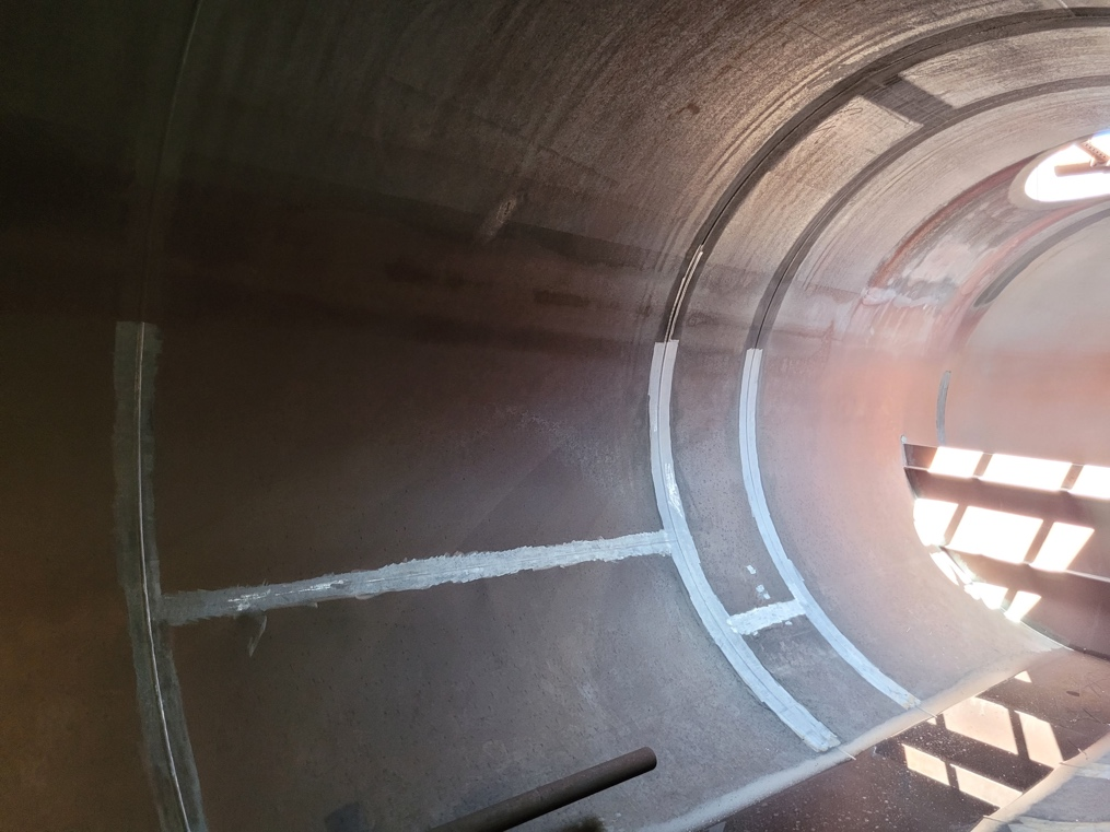 A close up of a tunnel with a staircase going down it.