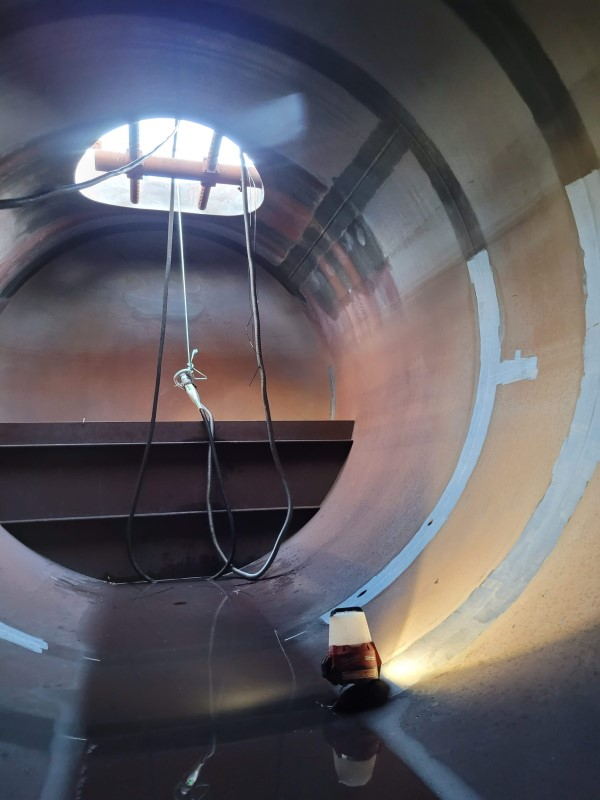 A large metal pipe with a window in the middle