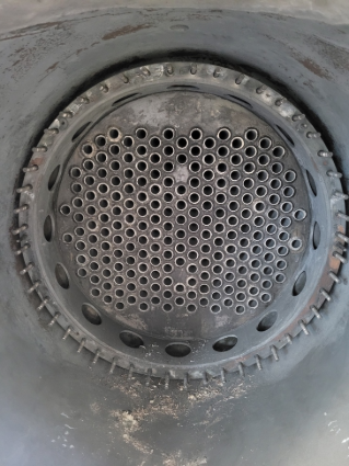 A close up of a metal pipe with holes in it