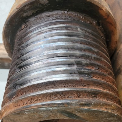 A close up of a rusty metal object on a wooden table.