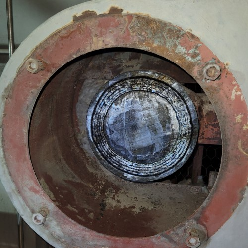 A close up of a metal object with a hole in the middle