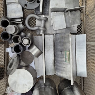 A bunch of metal pieces are laying on a table