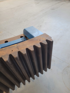 A close up of a metal gear on a table