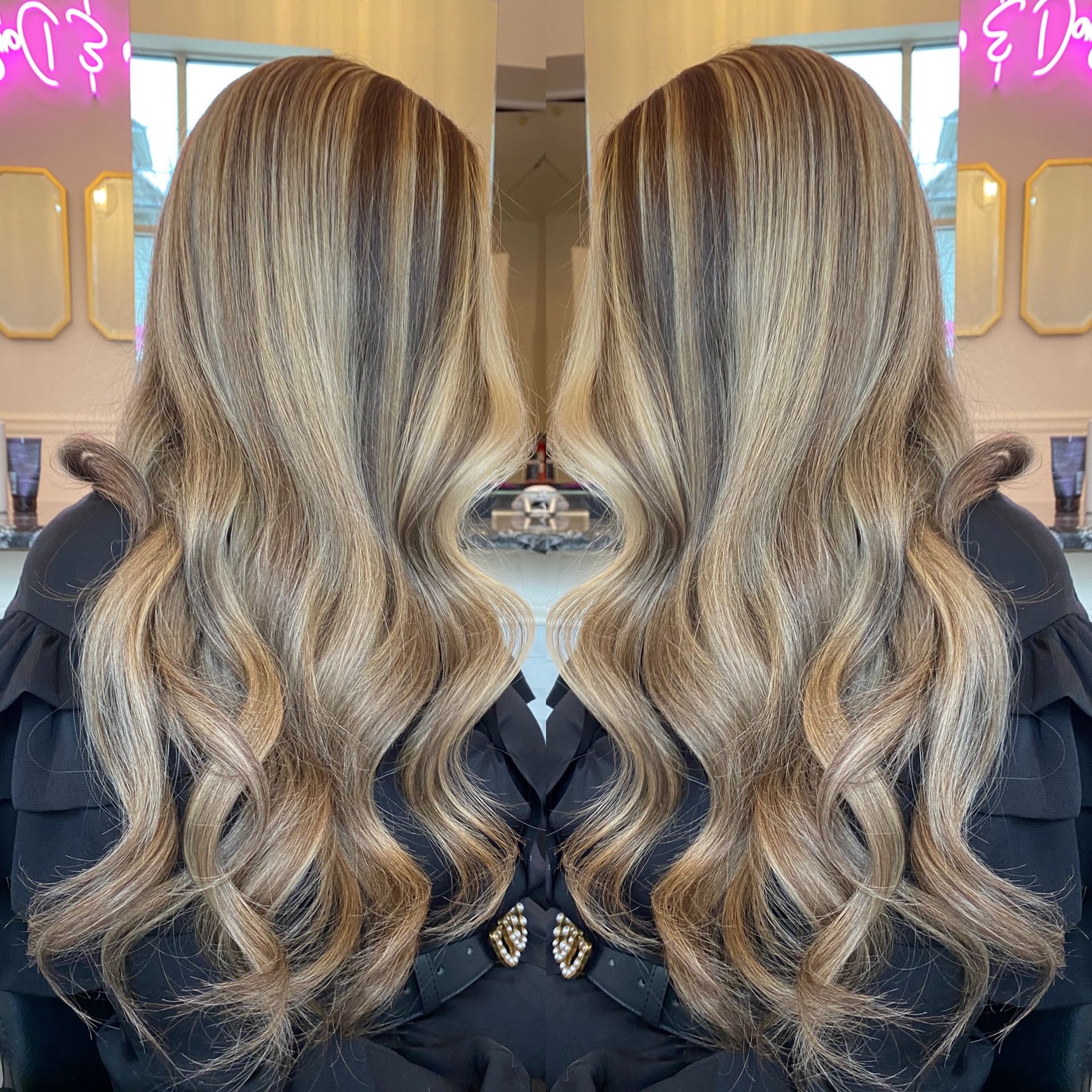 A woman with long blonde hair is standing in front of a mirror.