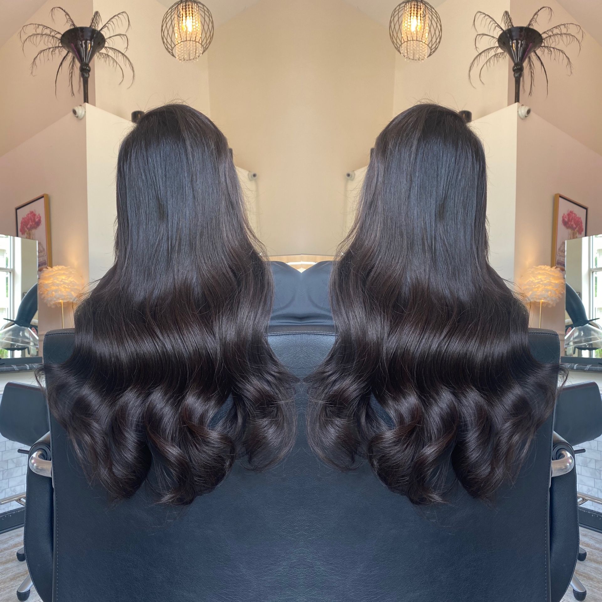 A woman with long dark hair is sitting in a chair