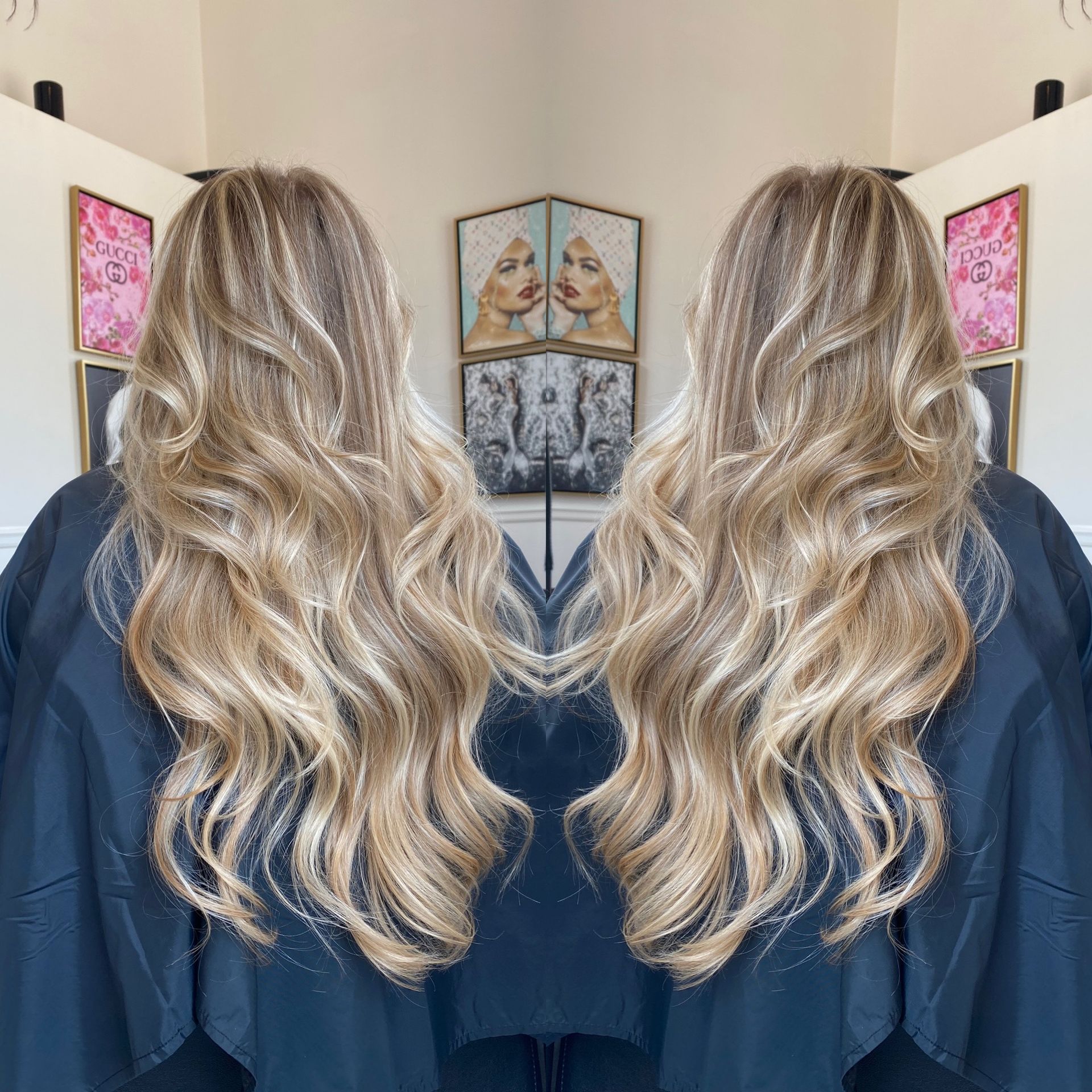 A woman with long blonde hair is standing in front of a mirror.