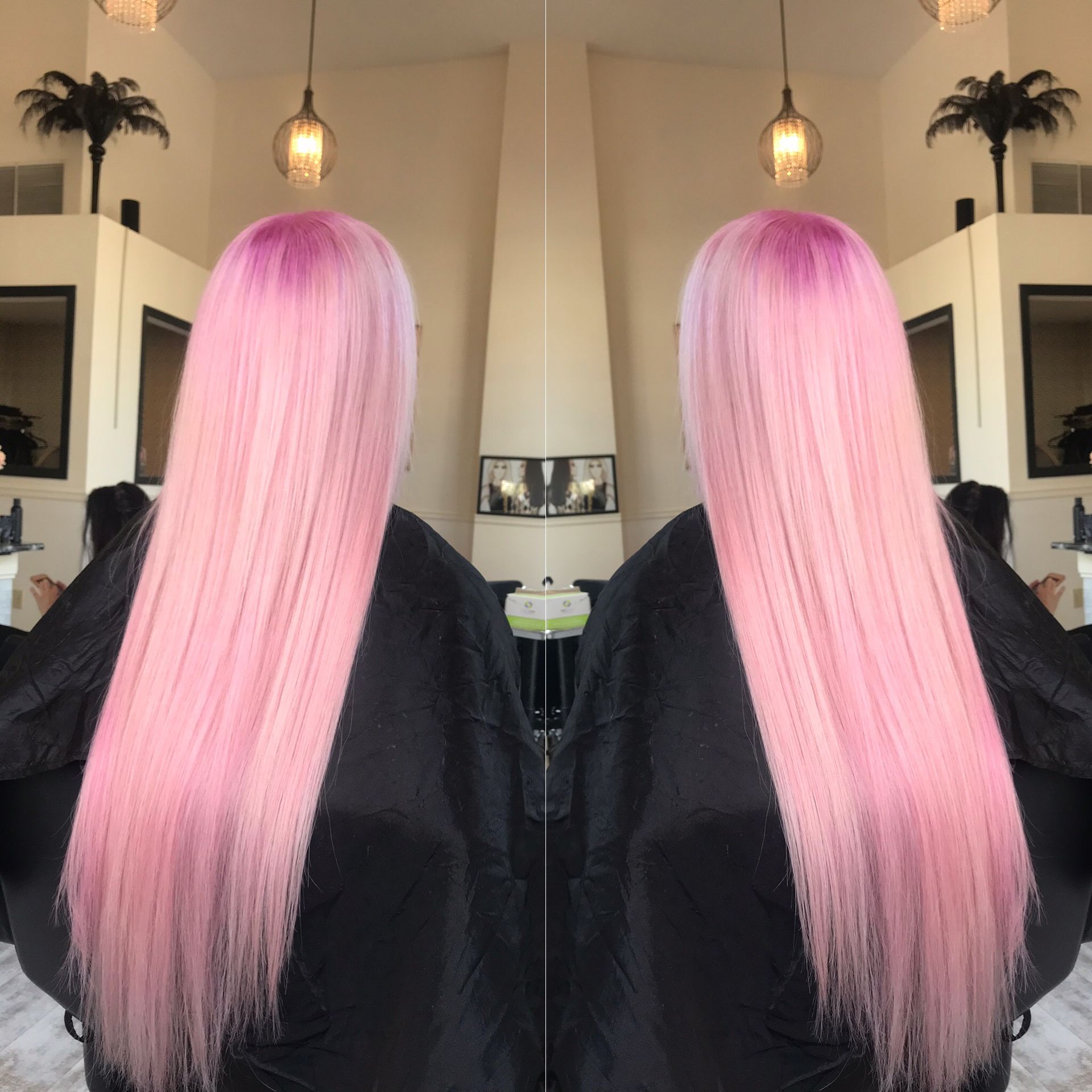 A woman with long pink hair is getting her hair cut