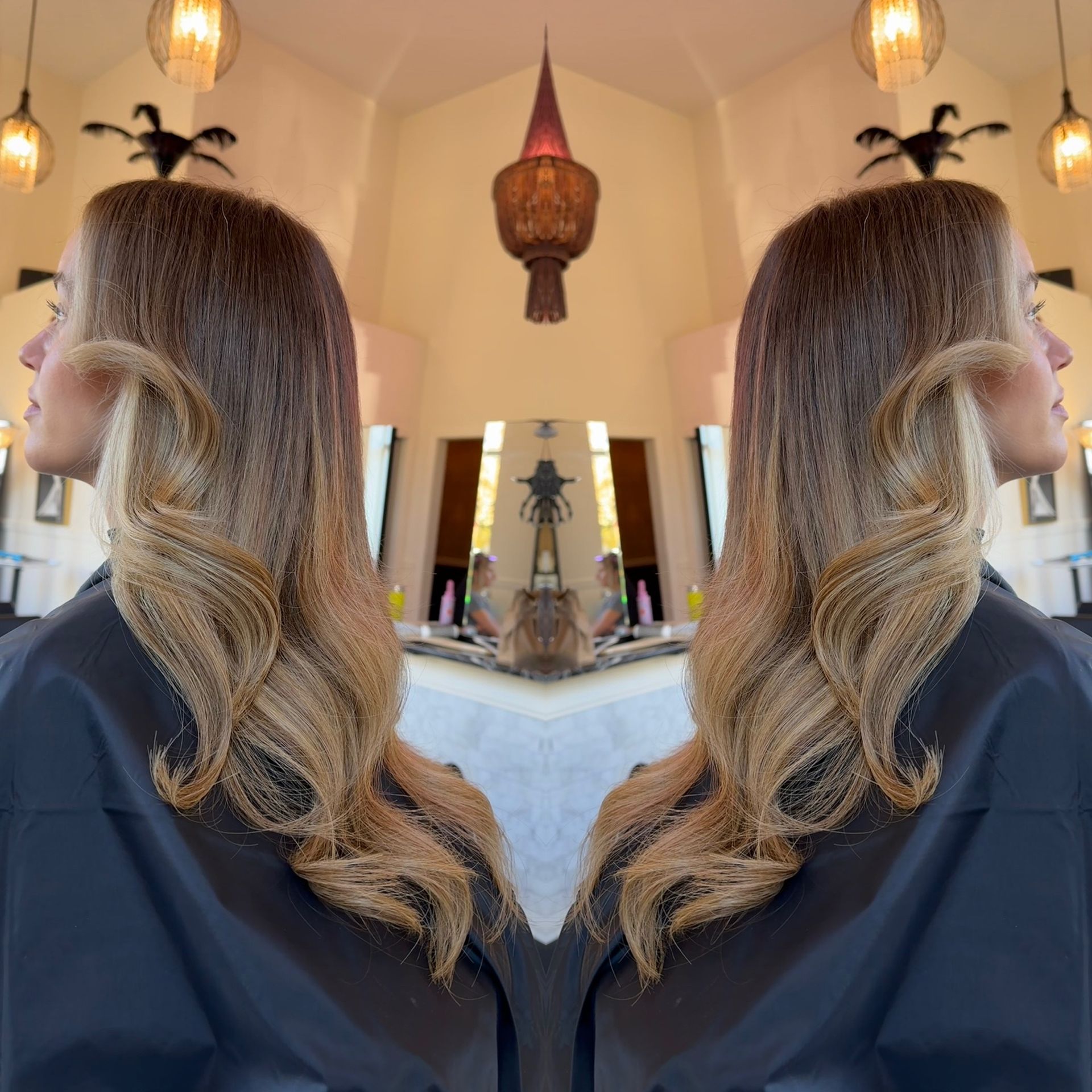 A reflection of a woman 's hair in a mirror
