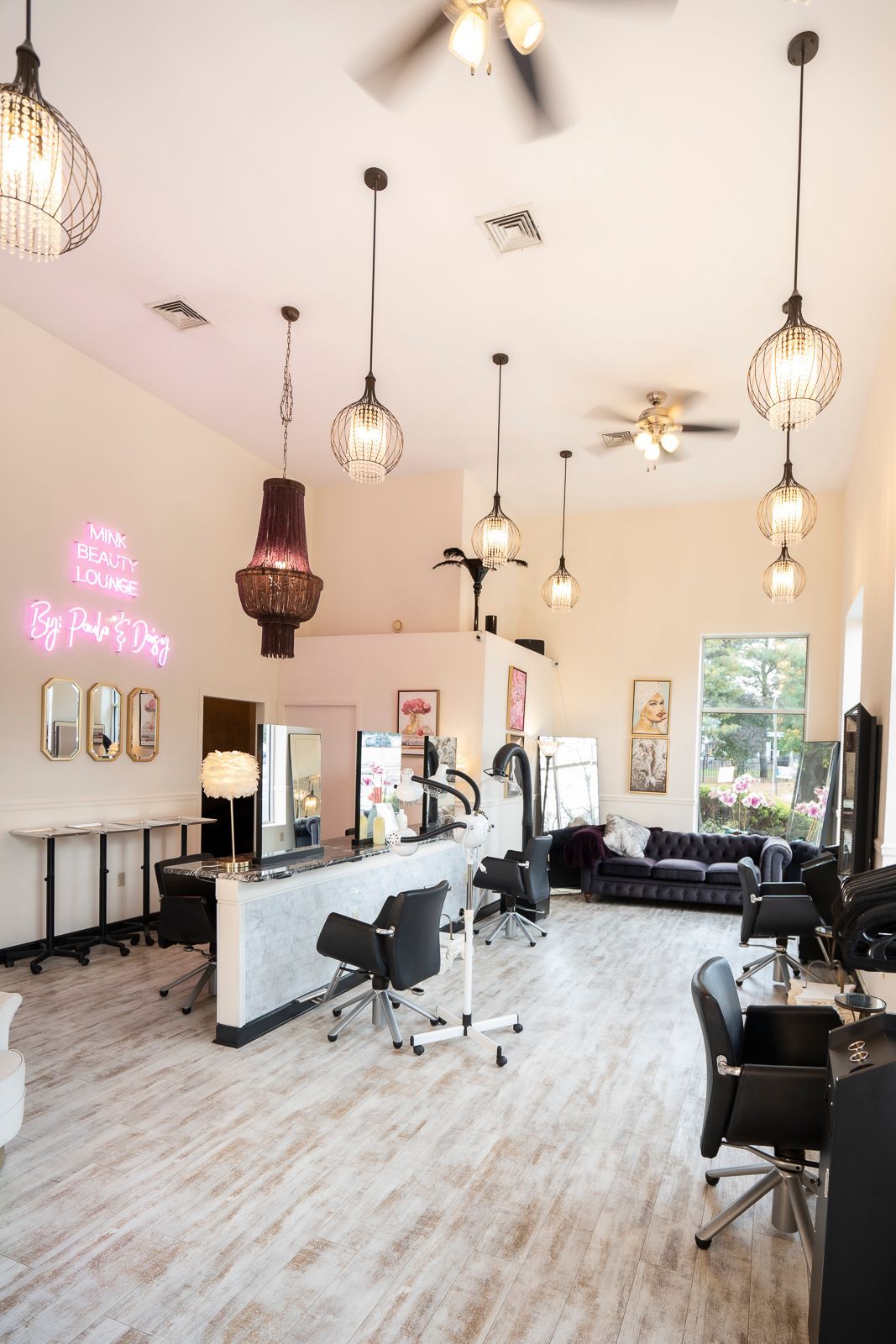 A large room with a lot of lights hanging from the ceiling in a salon.