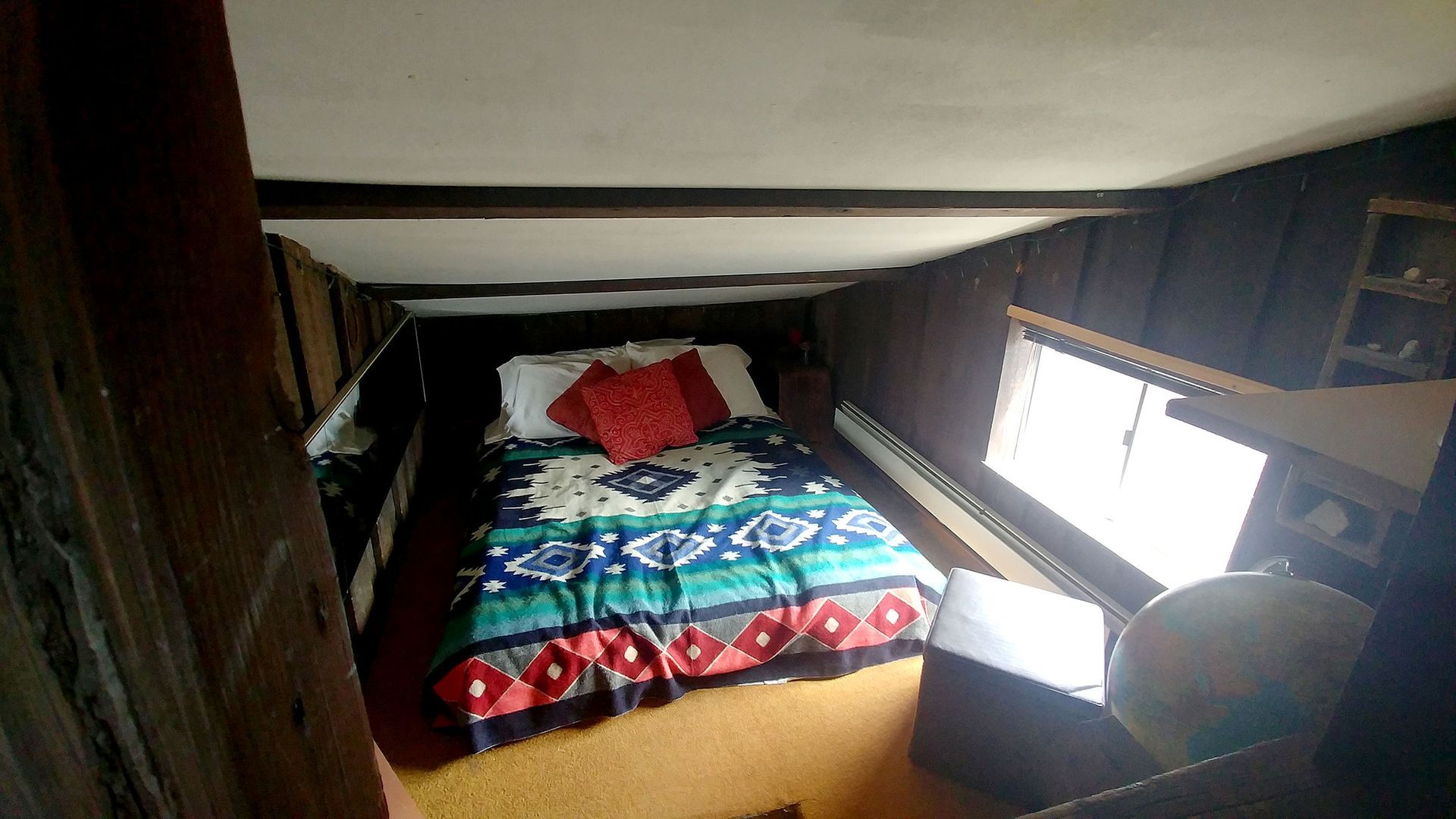 A bedroom with two bunk beds and a rug.