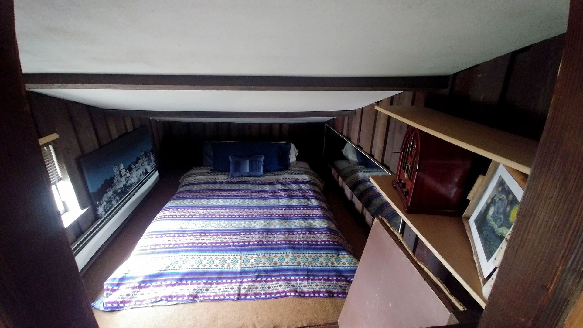 A bedroom with a bunk bed , dresser , and rug.